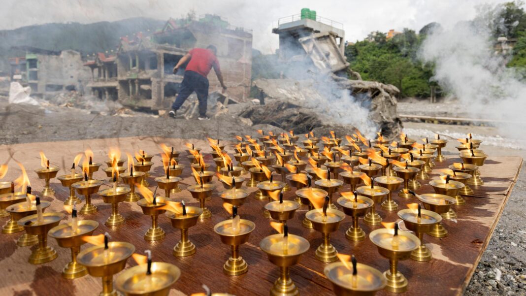 Nepal observes national day of mourning for victims of flash flood disaster Oil lamps burn as Buddhist monks perform a 13th-day ritual in front of a house damaged by flash floods.
