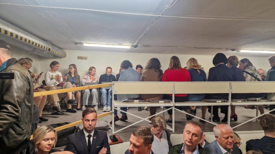 People gather inside a shelter at the Lithuanian parliament after an 'air danger' warning.