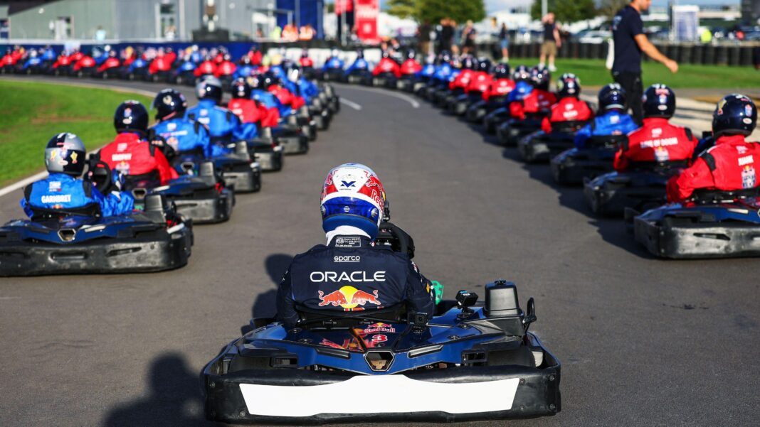 Verstappen passes 100 amateur karters in 14 laps in exhibition race A photo from behind Max Verstappen at the back of the grid before the start of his 'Max vs 100' go-kart challenge