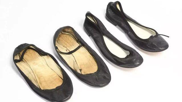 Brigitte Bardot's worn black leather ballet flats. One pair is heavily worn.