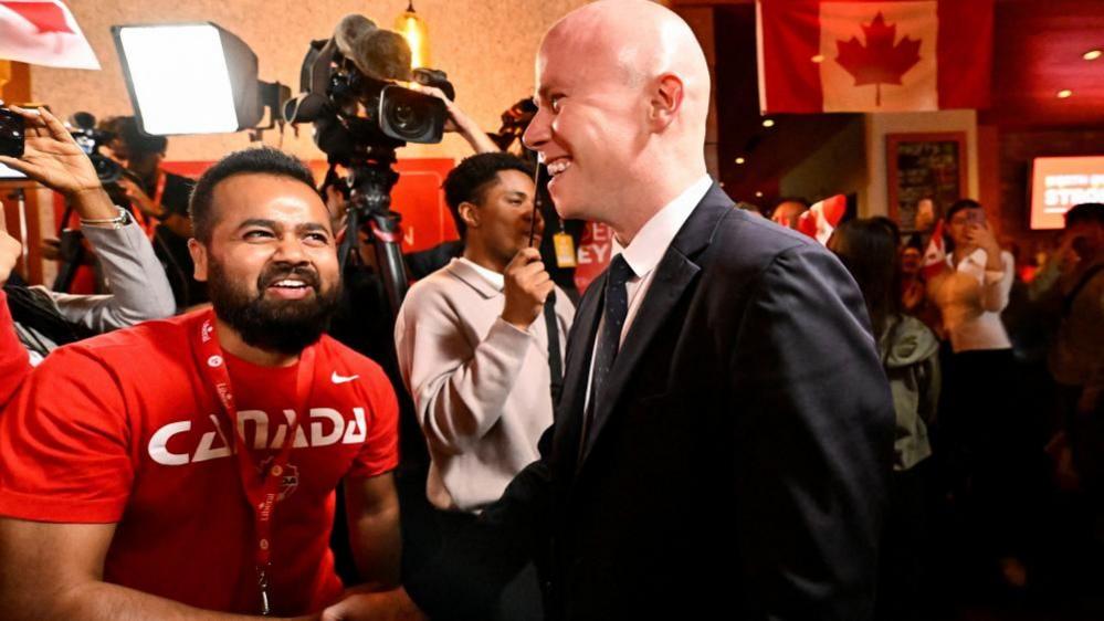 Braeden Caley shakes the hand of a supporter during celebrations for his win in the North Vancouver-Capilano seat