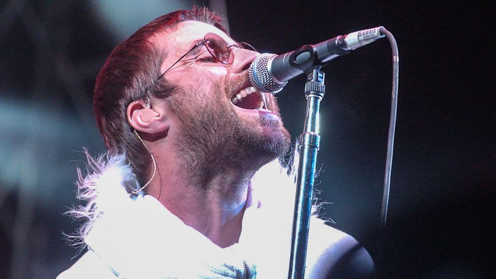 Liam Gallagher of Oasis performs on the Pyramid Stage during the 2004 Glastonbury Festival held at Worthy Farm, in Pilton, Somerset on June 25, 2004 near Glastonbury, England.