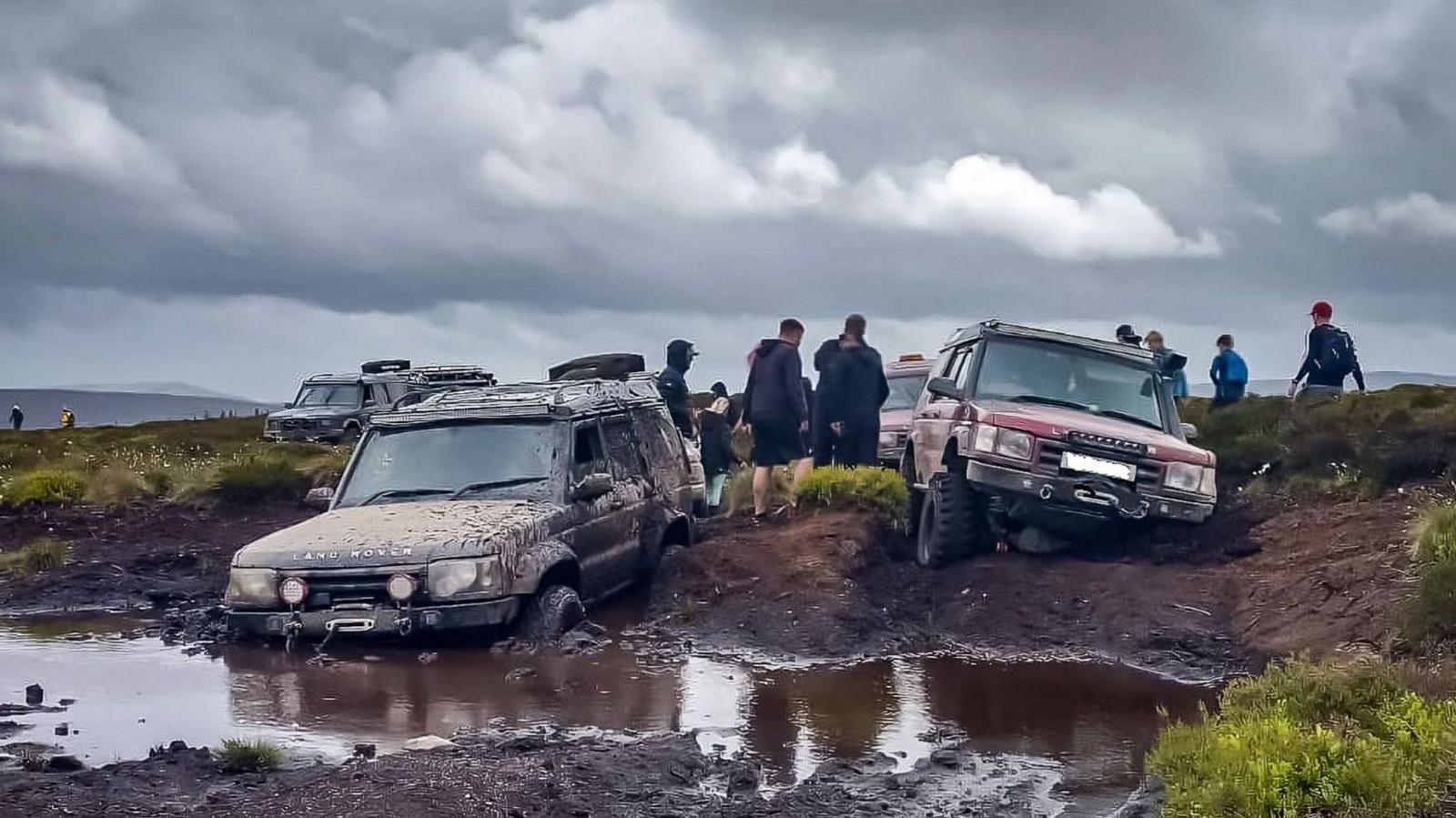 Two 4x4 vehicles are seen trapped in bogland