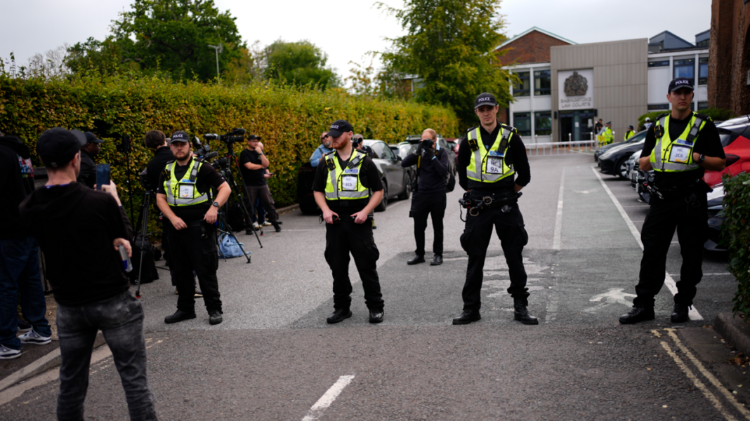 Media, police officers and supporters outside Basingstoke Magistrates' Court, Hampshire, where far-right activist Daniel Thomas, also known as Danny Tommo, is due to appear charged with criminal damage and failing to disclose the PIN to his phone, after he was filmed slashing a boat in the English Channel with a rescue crew member on board