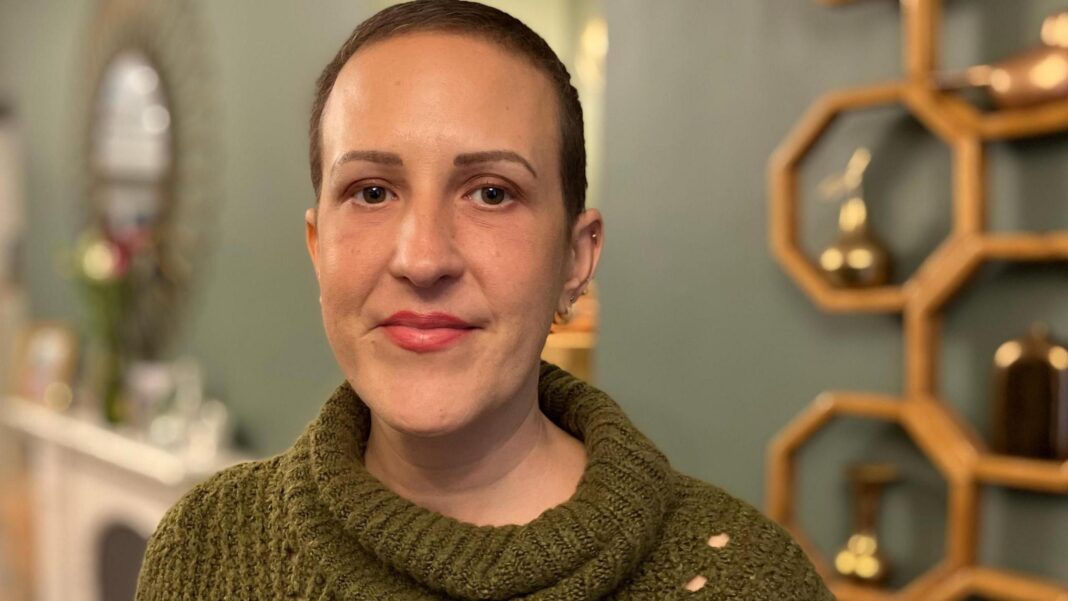New hope for breast cancer patients as life-extending drug now on NHS in England Rachel Davies standing in her living room during her campaign to make the life-extending drug Enhertu to be made available through the NHS in Wales. She is wearing a green jumper, and facing the camera.