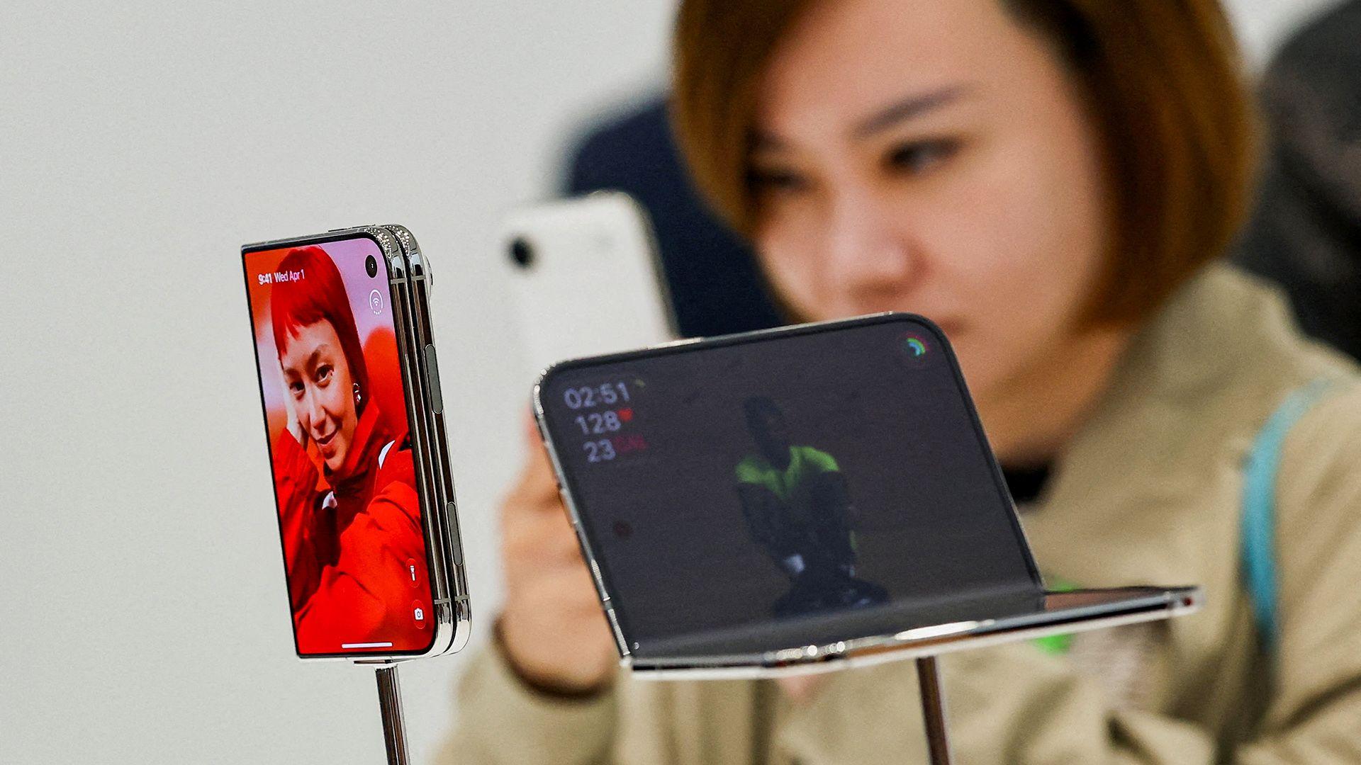 A person looks closely at the new iPhone Duo on display at a launch event in Cupertino, California on Wednesday.