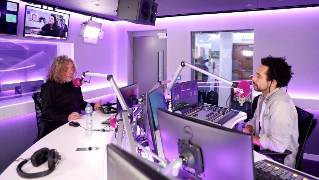 Ben Earle interviewing Robert Plant in a radio studio bathed in pink light