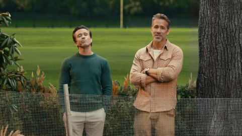 Rob Mac and Ryan Reynolds stand next to a tree