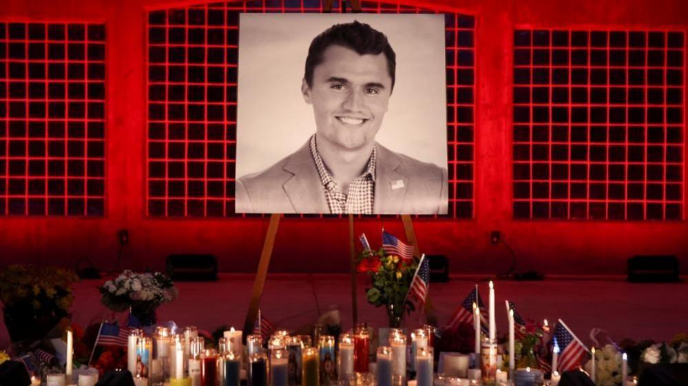 Candles and flowers are placed near an image of Charlie Kirk, during a vigil at Orem City Center Park, after U.S. right-wing activist and commentator, Charlie Kirk.
