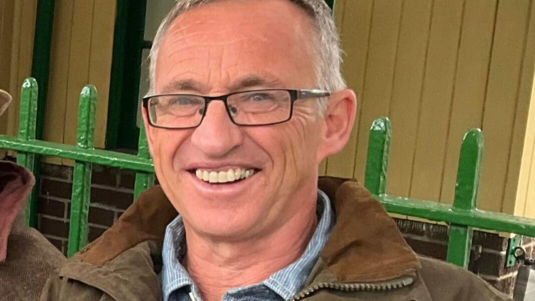Widow whose husband died after falling into slurry pit warns of pressure on farmers An older man with short white hair and glasses, wearing a brown coat, is smiling at the camera