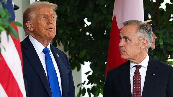 US President Donald Trump speaks to Canadian Prime Minister Mark Carney  during a welcome outside the West Wing of the White House in October 2025