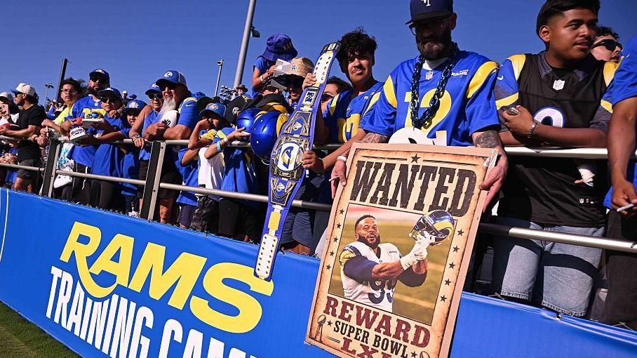 Los Angeles Rams fans at a pre-season training camp with one holding an Aaron Donald poster