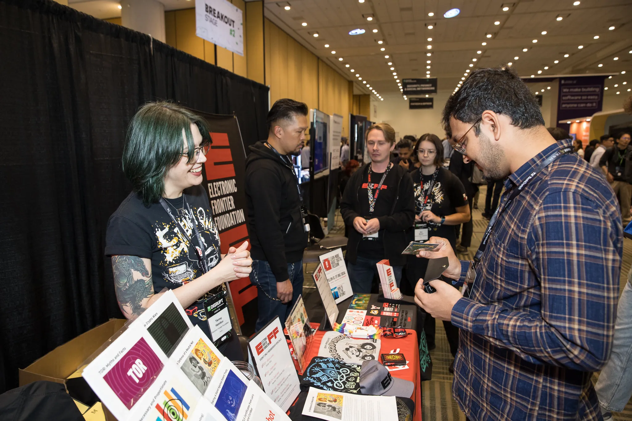 visiting an exhibit table at TechCrunch Disrupt 2024