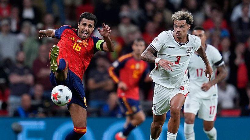 Spain midfielder Rodri and England defender Nico O'Reilly battle for possession