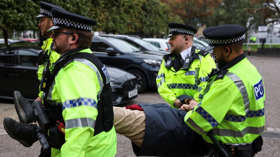 More than 50 arrested at Palestine Action support rally Police officers wearing yellow hi-vis jackets remove an anonymous Palestine Action supporter amid a protest outside the Labour Party’s annual conference in Liverpool.