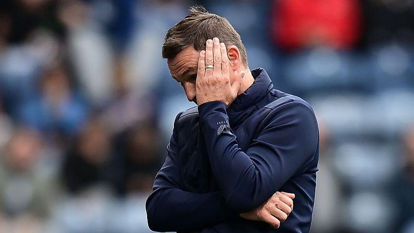 Paul Heckingbottom covers his face with his hands during Preston's home defeat to Lincoln City.