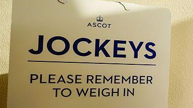 A photo of a sign that says 'Please remember to weigh in' at Ascot racecourse