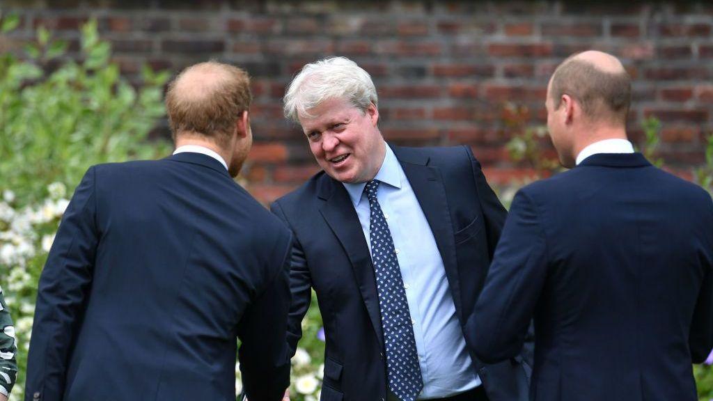 Earl Spencer shaking the hand of his nephew Prince Harry with Prince William beside him