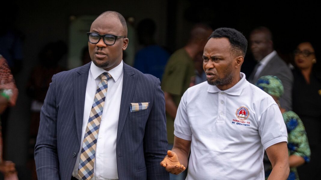 Joshua’s driver attempted overtake before fatal crash, trial hears Kayode is wearing a white t-shirt and is gesticulating as he speaks to his lawyer - who is dressed in a blue suit - as he leaves court