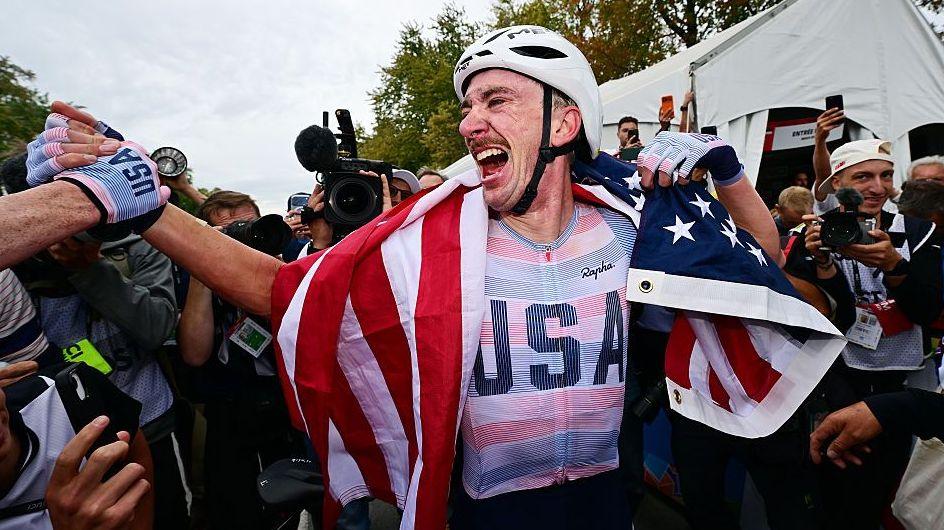 Brandon McNulty celebrating with the American flag after his win.