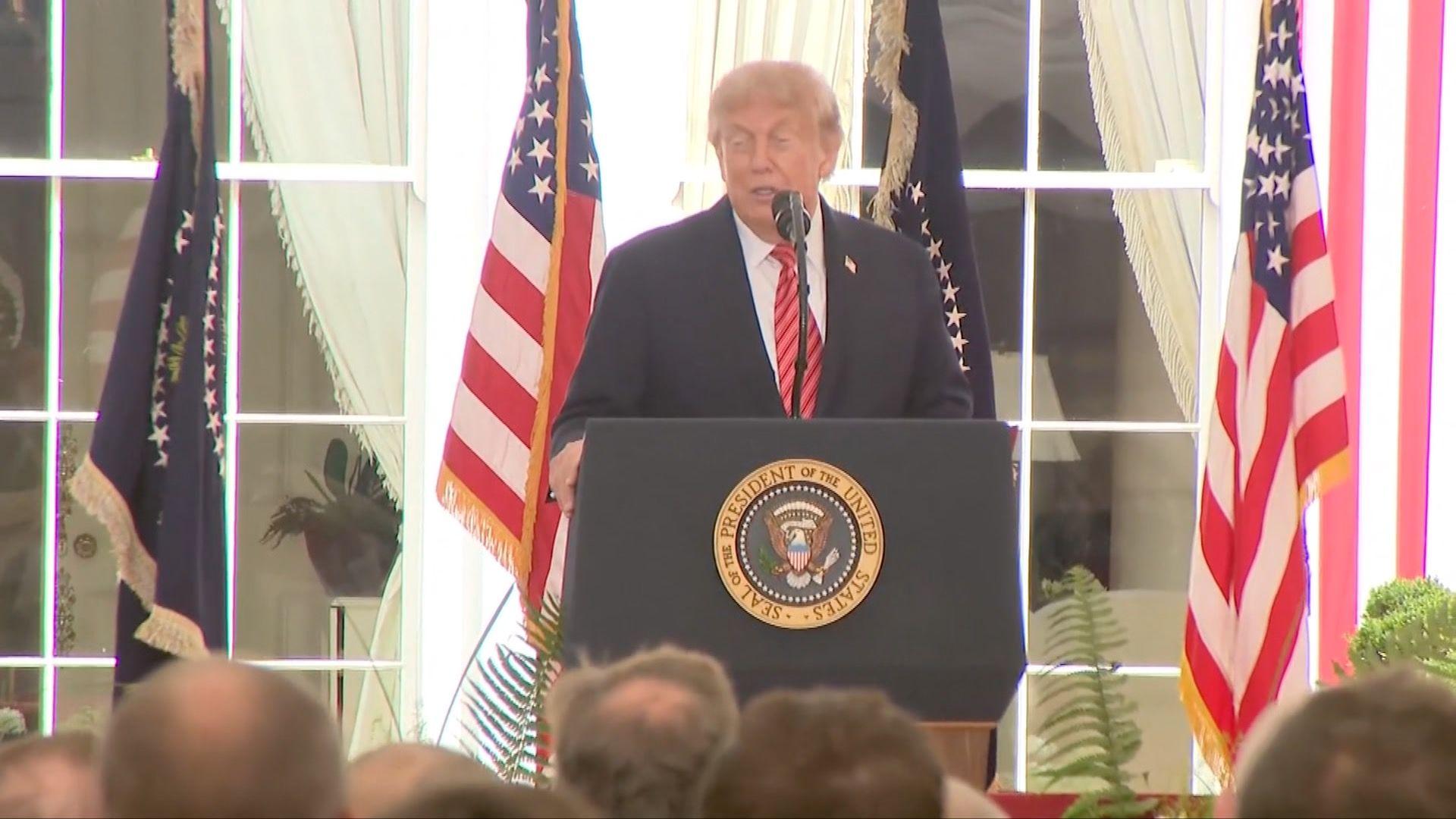 Donald Trump standing in front of a podium
