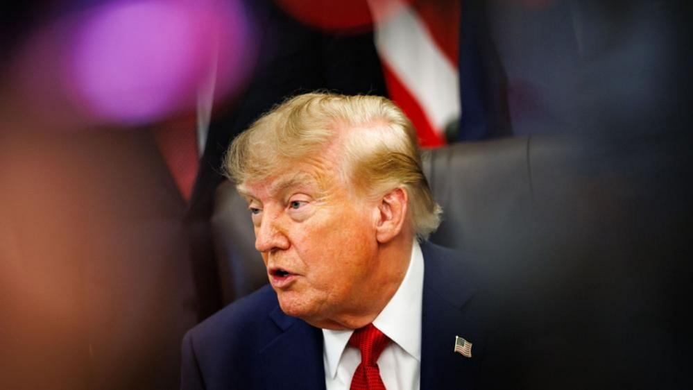 US President Donald Trump answers questions