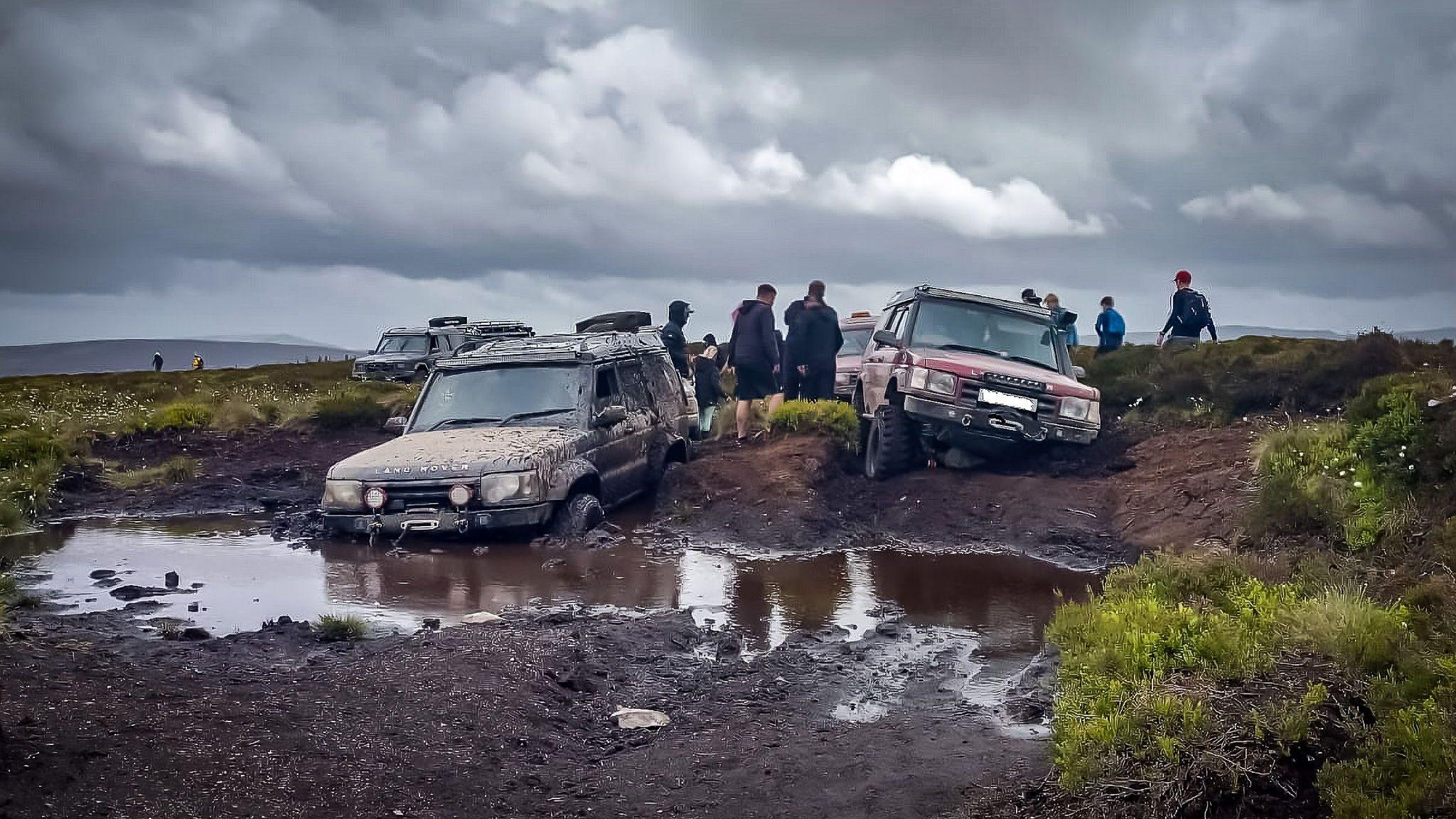 Two 4x4 vehicles are seen trapped in bogland