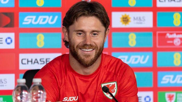 Wes Burns at a Wales press conference