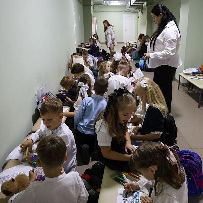 Schoolchildren can be seen working in a shelter