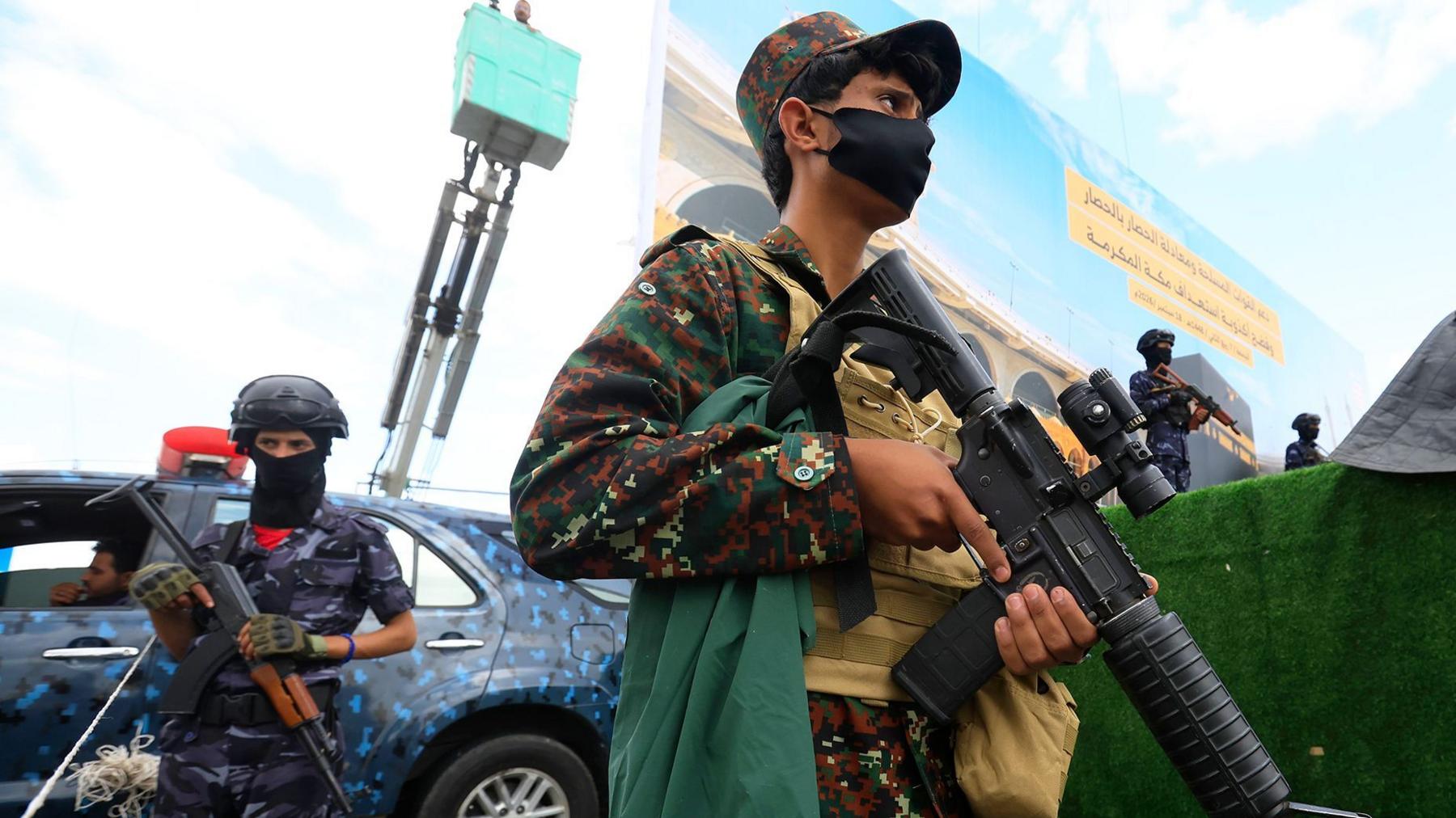 Houthi troopers stand guard during a protest against Saudi Arabia, in Sana'a, Yemen.