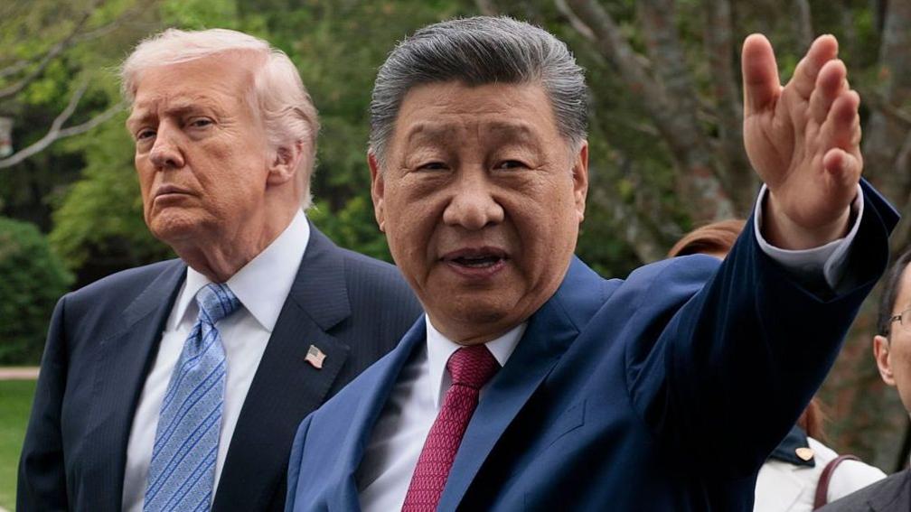 US President Donald Trump listens on as Chinese leader Xi Jinping takes him on a tour of China's Zhongnanhai Garden in Beijing on 15 May, 2026.