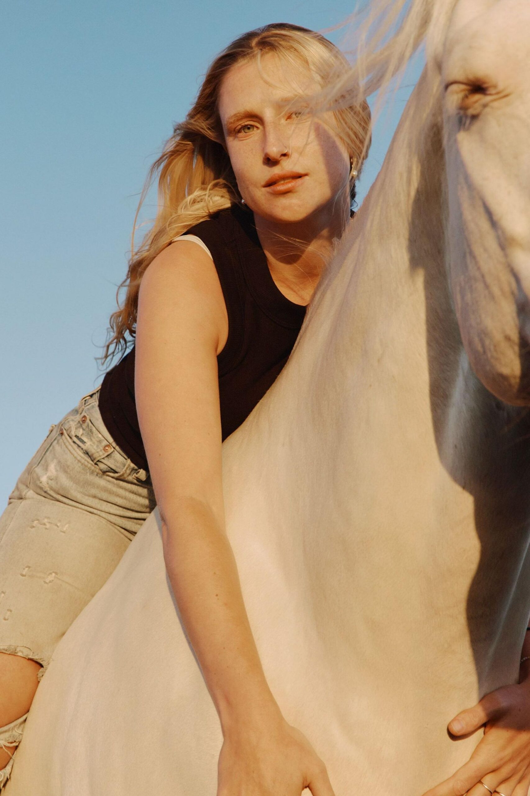 Singer-songwriter Billie Marten riding a white horse