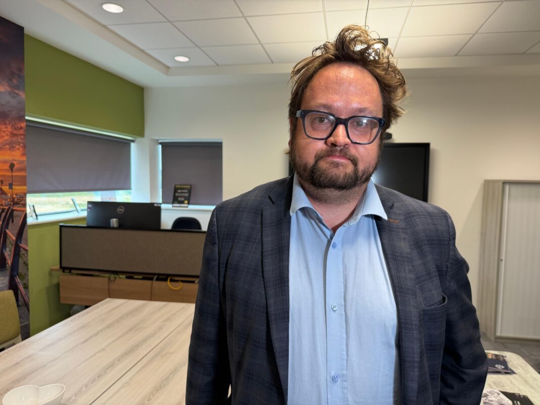 Fatal crash police get £2m to tackle serious crime Matt Storey is standing in a room, surrounded by light wooden tables and a desk with a computer in the background. He has dark messy hair and a beard. He wears glasses, a light blue shirt and grey jacket. He is looking at the camera with a serious expression.