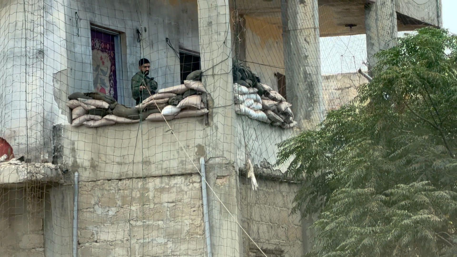 Israeli soldier is seen at a checkpoint established in a residential building in Naqoura
