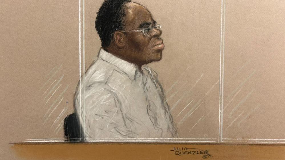 Court sketch of Dr Vincent Brown, a black man with short dark hair and glasses sat behind a glass screen in a white shirt.