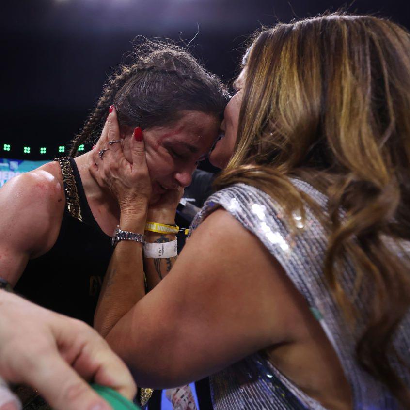 Bridget Taylor kisses her daughter Katie on the head