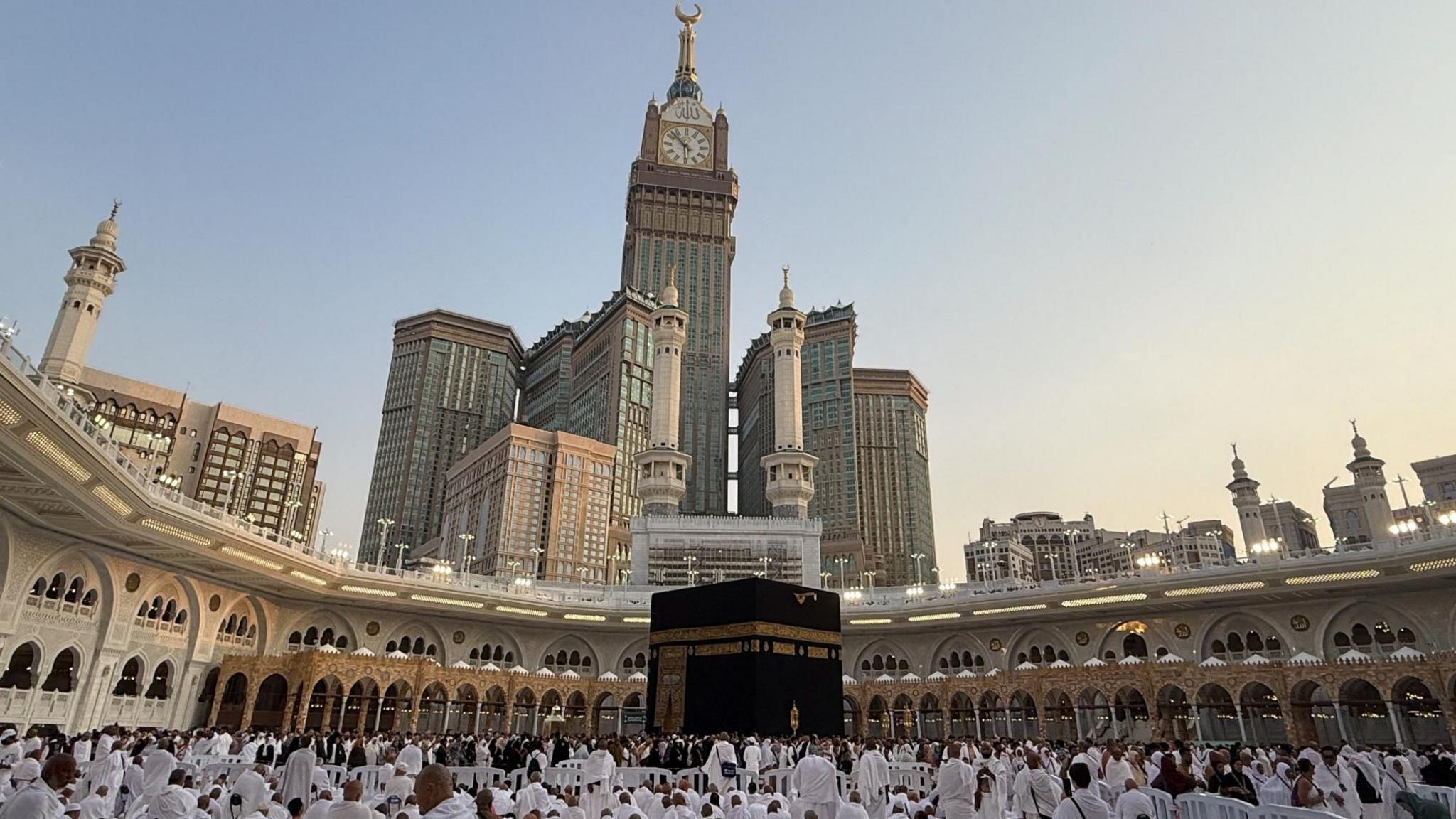 Muslims stand beside the Kaaba at the Grand Mosque in the holy city of Mecca, Saudi Arabia (14 September 2026)
