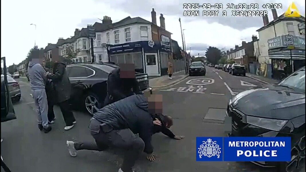 How ‘largest phone smuggling network’ was uncovered Police bodycam footage shows two officers arresting a man, who is on his hands and knees on the road, beside some parked cars in a residential street. To their left, are three other individuals, their faces blurred.