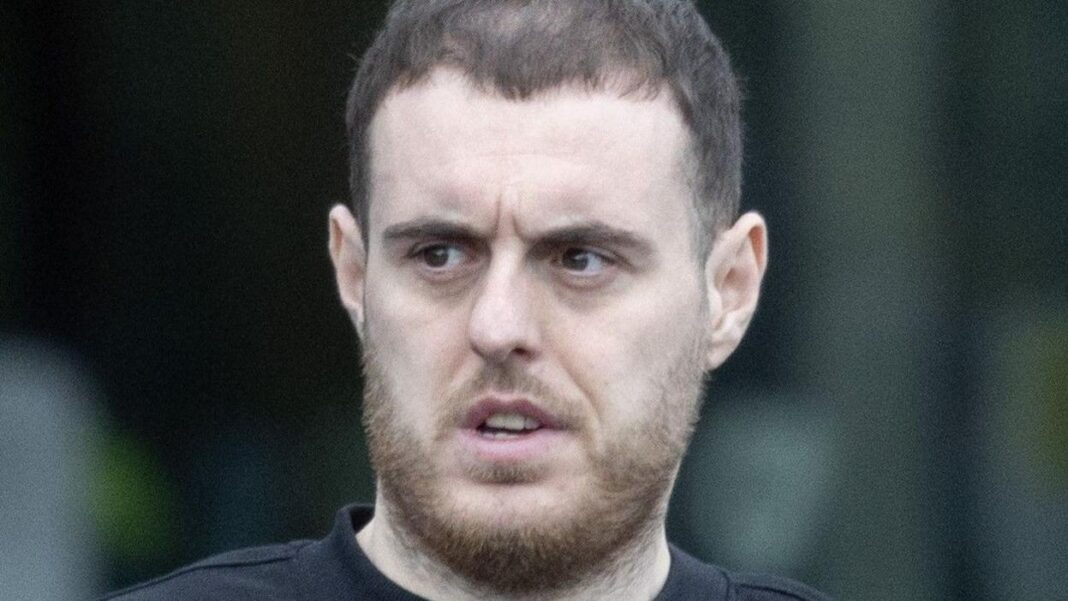 On-the-run killer Gary Anderson appears in court Gary Anderson pictured attending court on Thursday. He has short brown hair and a beard. He is wearing a black jumper and is seen walking in the rain.