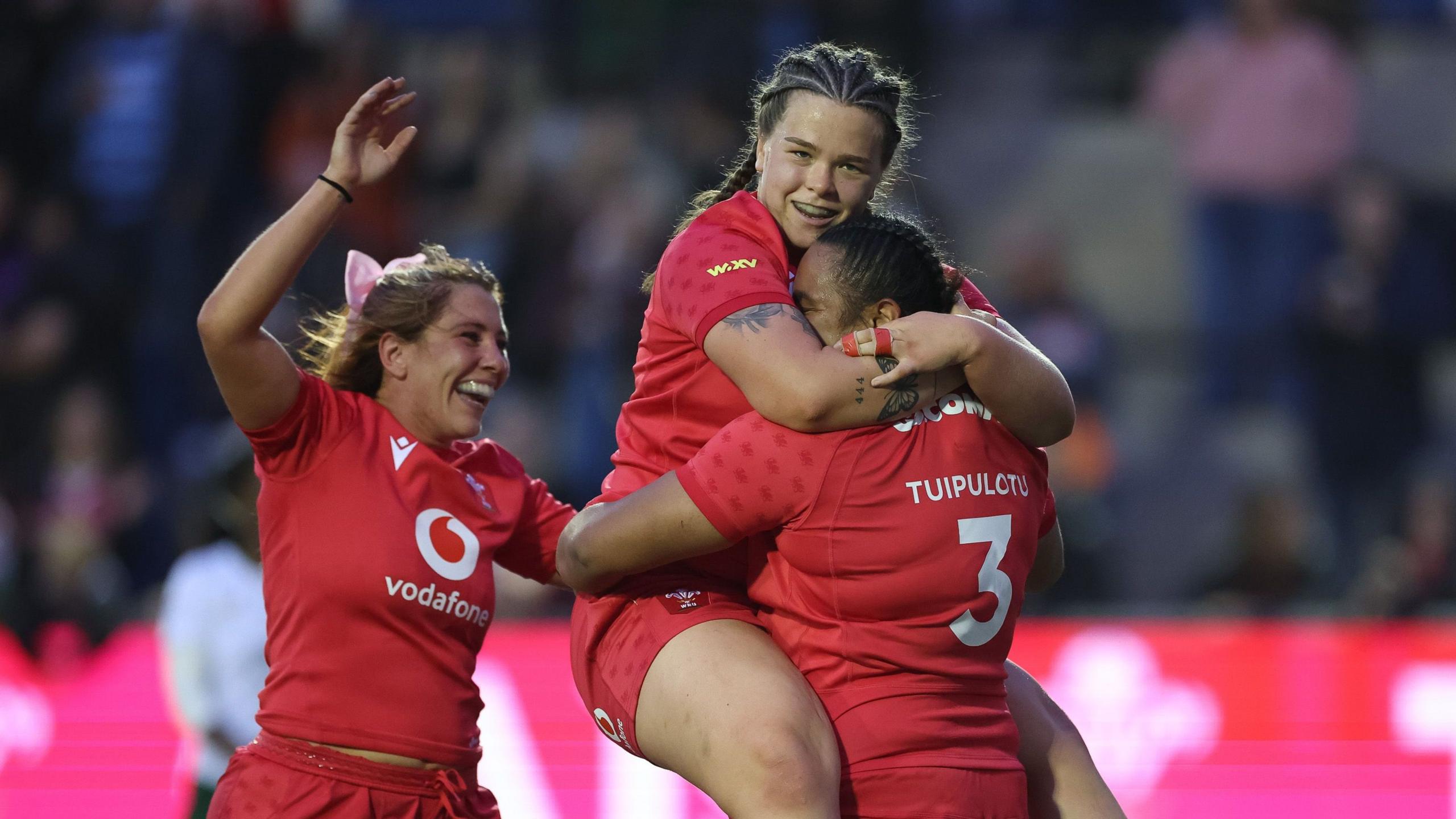Prop Sisilia Tuipulotu celebrates with Maisie Davies