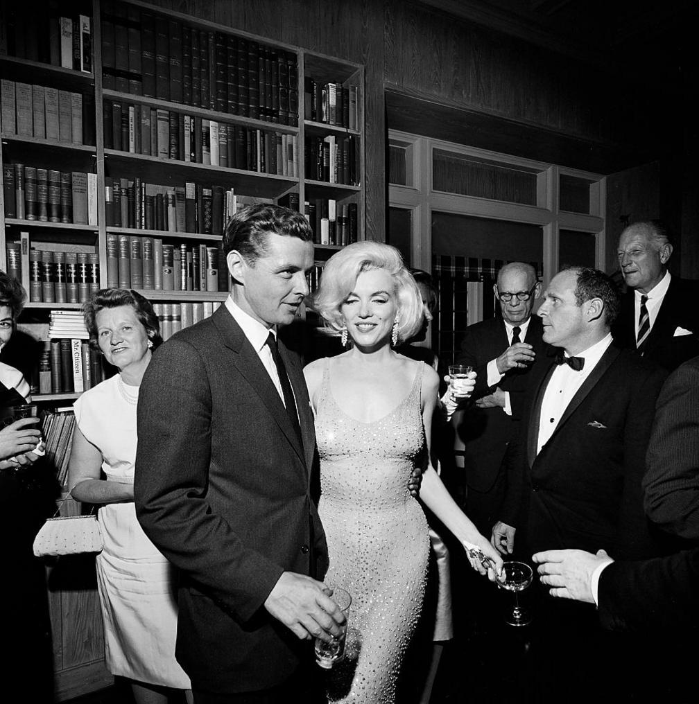 Steven E. Smith, brother-in-law of U.S. President John F. Kennedy, visiting with actress Marilyn Monroe during reception at the residence of Arthur B. Krim and Dr. Mathilde Krim, New York City, New York, USA, Cecil Stoughton, White House Photographs,, May 19, 1962.