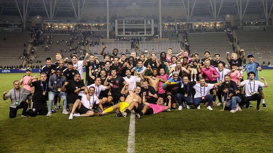 Sabah pose for a group photo on the pitch after qualifying for the Champions League
