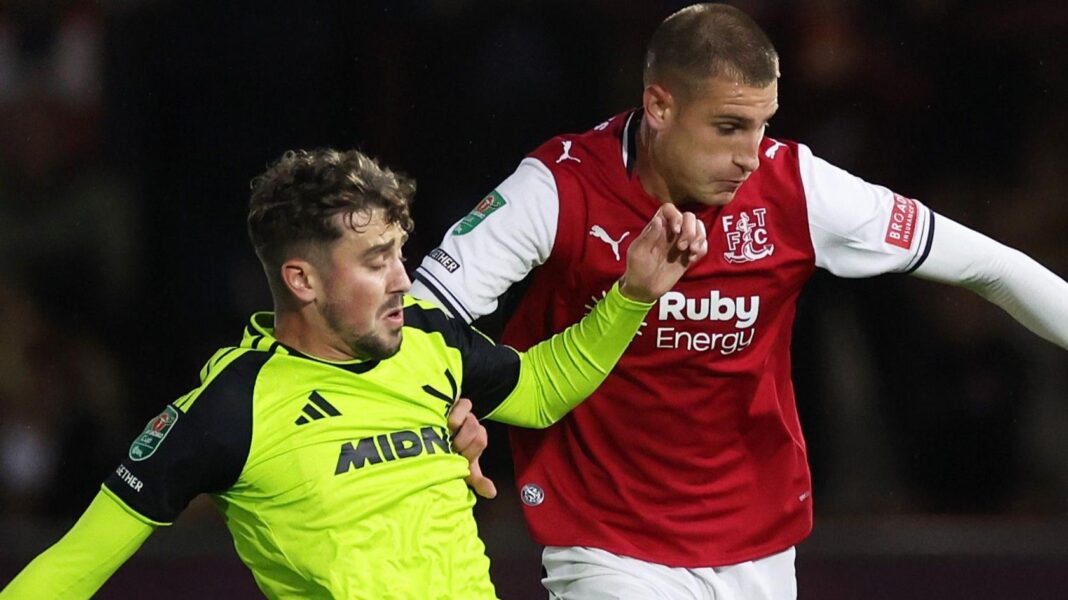 Fleetwood Town and Sheffield United players challenge for the ball