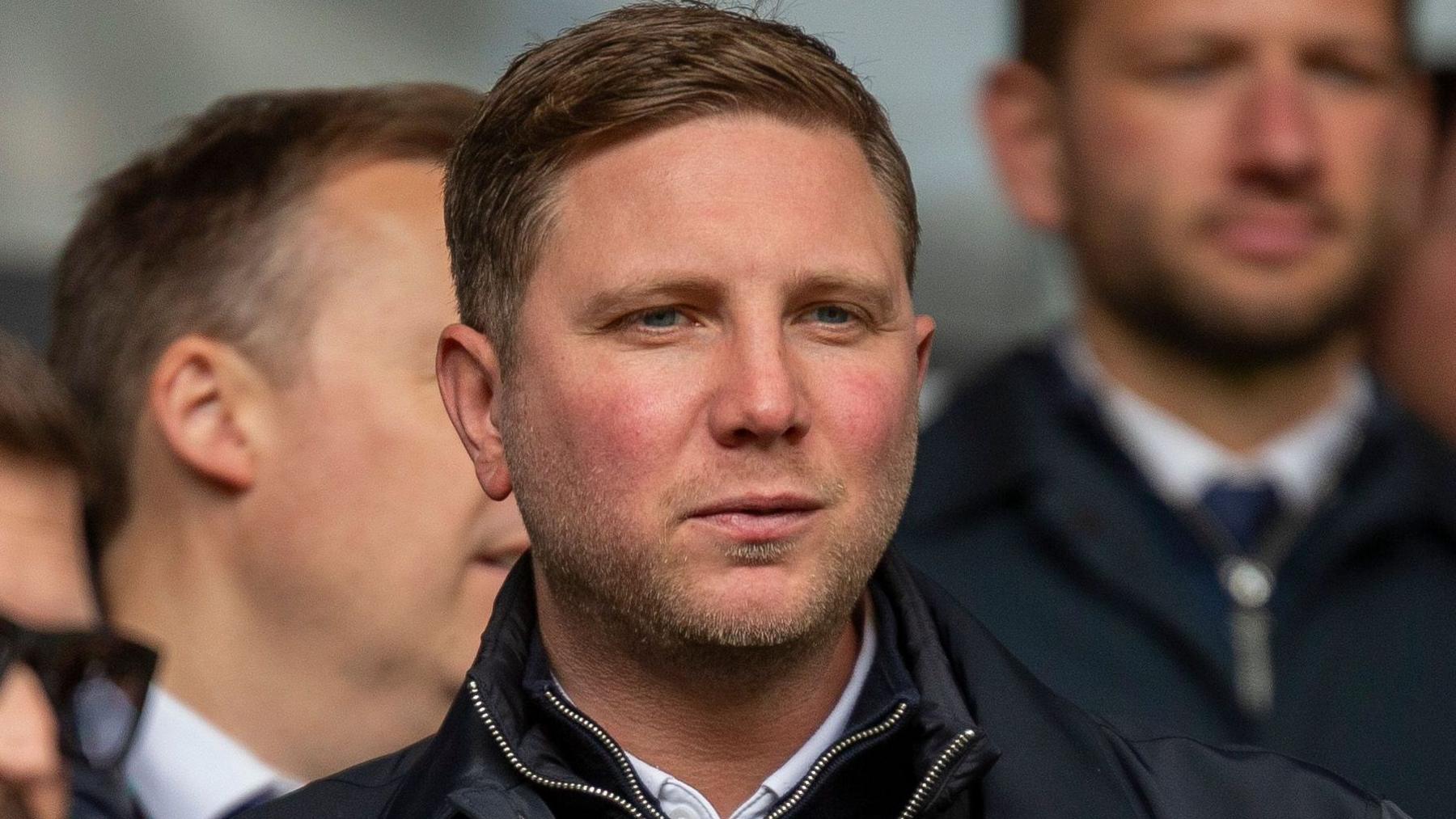 Ben Knapper wearing a navy blue coat