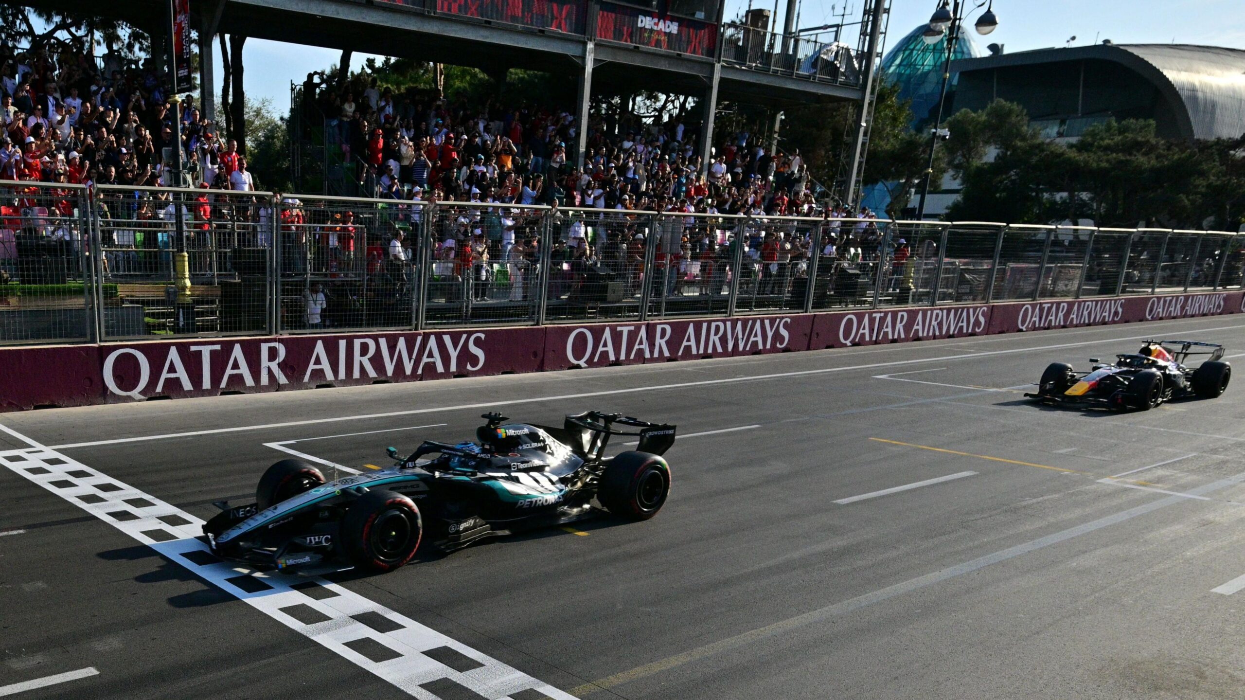 Mercedes' George Russell crosses the finish line with Red Bull's Max Verstappen just behind to win the Azerbaijan Grand Prix