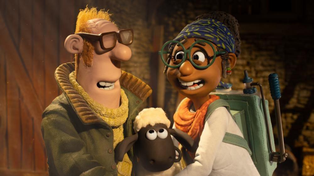 A still from Shaun the Sheep showing Shaun in the middle of two characters including the Farmer