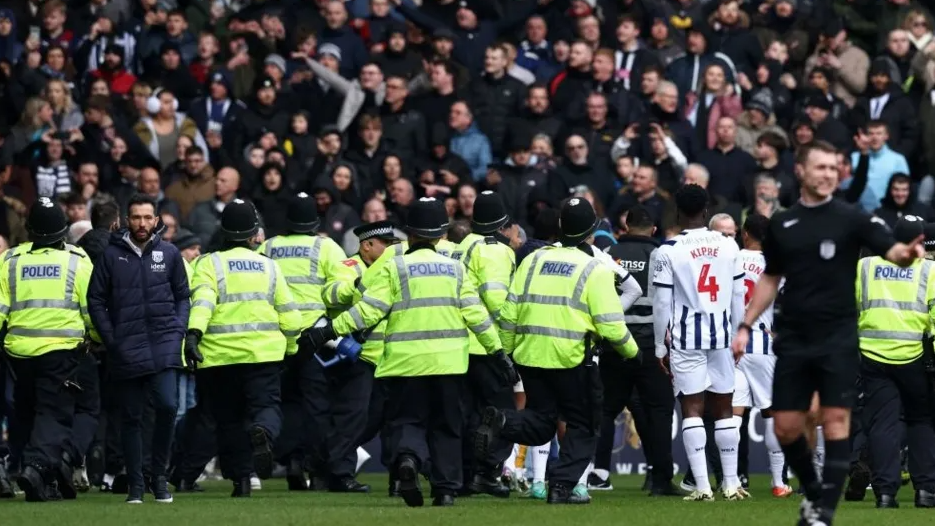 Police officers are among those at the bottom of the photo, with fans in the stand in the top half of the image.