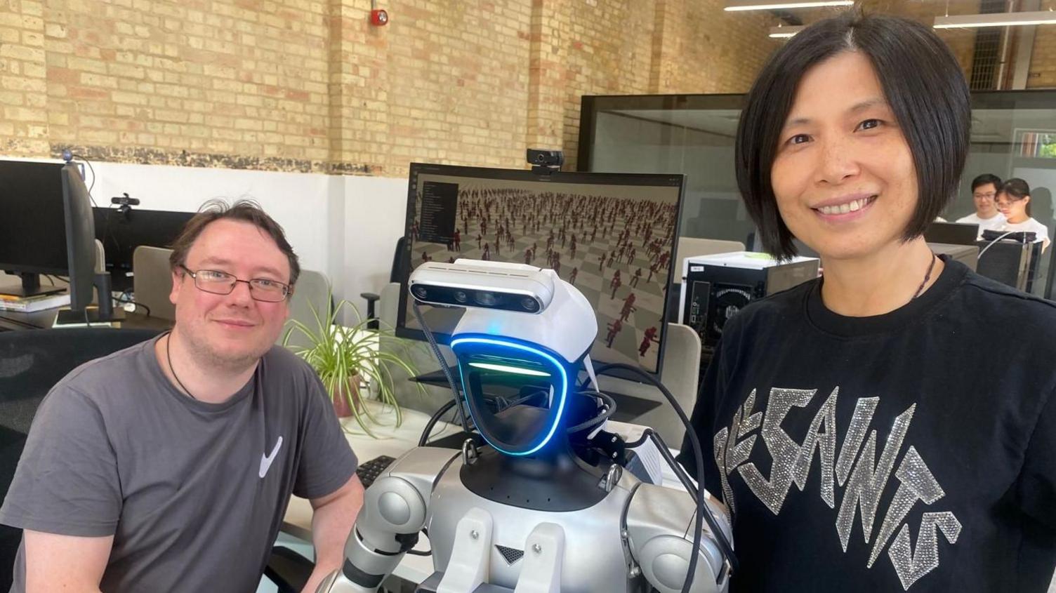 Founders Michelle Lu and Kier Storey are either side of Freddo the robot.