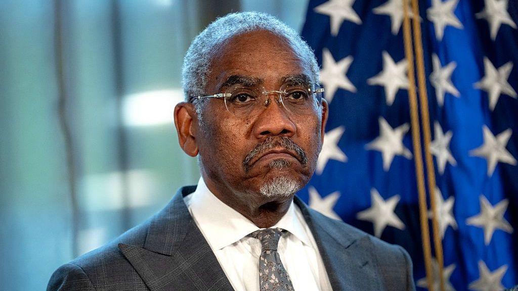 US congressman Gregory Meeks frowns in front of an American flag while attending a press conference