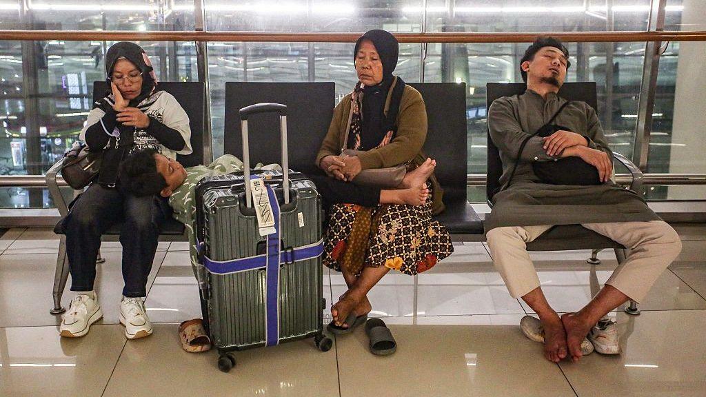Stranded passengers rest on a bench at Soekarno-Hatta Airport in Tangerang on September 6, 2026